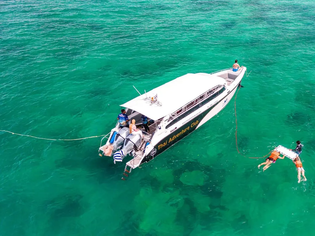 Phuket: Phi Phi Islands & Maya Bay Day Trip with Lunch — longtail boat and island scenery near Ko Phi Phi Leh (photo 3)