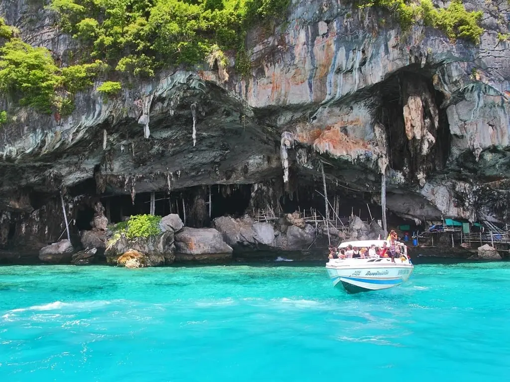 From Phuket: Phi Phi Islands, Maya Bay & Khai Nok Tour — longtail boat and island scenery near Ko Phi Phi Leh (photo 3)